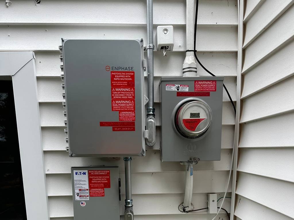Solar disconnect switch and utility meter on the side of a home