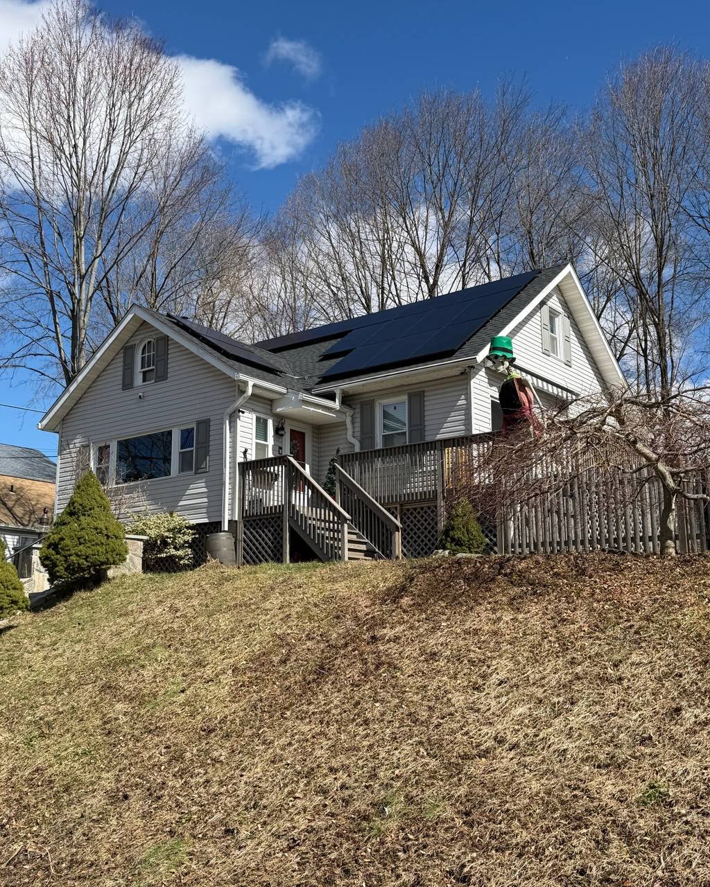 Hillside cottage with solar panels on the side roof