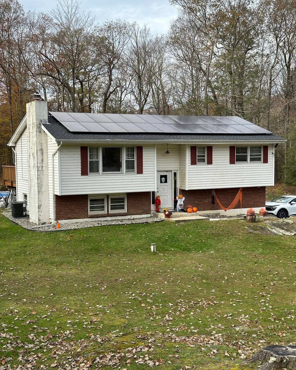 Raised ranch home with solar panels in early spring